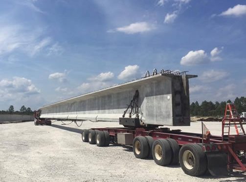 Pre-stressed Bulb T Beams for Belmont Bridge, on the back of a truck.
